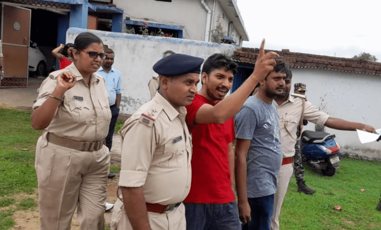 Independent Jharkhand journalist Rupesh Kumar Singh (in red shirt) being escorted by the police after his house was raided in 2022