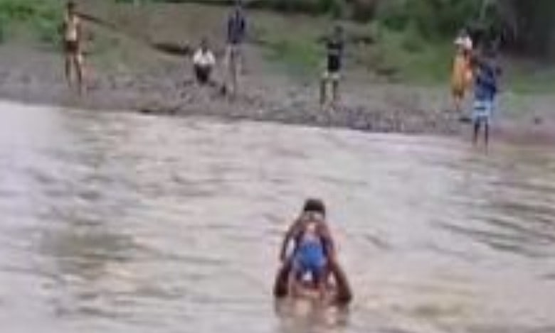 Telangana man wades through neck deep water with 8-month-old to reach hospital