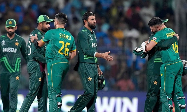 South Africa's batters Keshav Maharaj and Tabraiz Shamsi meet Pakistan players after winning the ICC Men's Cricket World Cup 2023 match against Pakistan, at MA Chidambaram Stadium, in Chennai