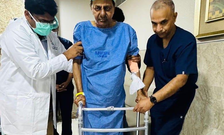 KCR back on his feet with walker support after hip replacement