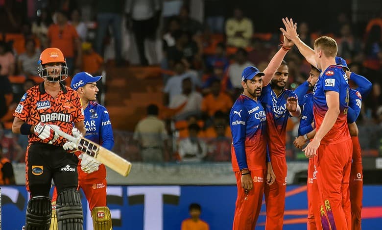 Royal Challengers Bengaluru players celebrate the wicket of Sunrisers Hyderabad batter Bhuvaneshwar Kumar during the Indian Premier League (IPL) 2024 match between Sunrisers Hyderabad and Royal Challengers Bengaluru, at Rajiv Gandhi International Cricket Stadium, in Hyderabad
