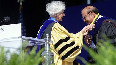 Dr. Krishna Ella Receiving Johns Hopkins Bloomberg School The Dean's Medal from Dean Ellen J. MacKenzie, for his exceptional leadership in safeguarding and improving global public health
