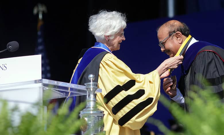 Dr. Krishna Ella Receiving Johns Hopkins Bloomberg School The Dean's Medal from Dean Ellen J. MacKenzie, for his exceptional leadership in safeguarding and improving global public health
