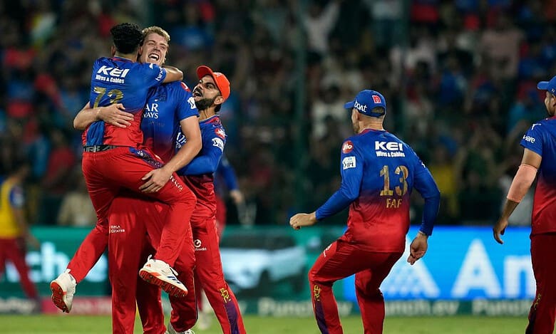 Royal Challengers Bengaluru's Camron Green celebrates with teammates after dismissing Delhi Capitals' Tristan Stubbs through a runout during an Indian Premier League (IPL) 2024 T20 cricket match between Royal Challengers Bengaluru and Delhi Capitals