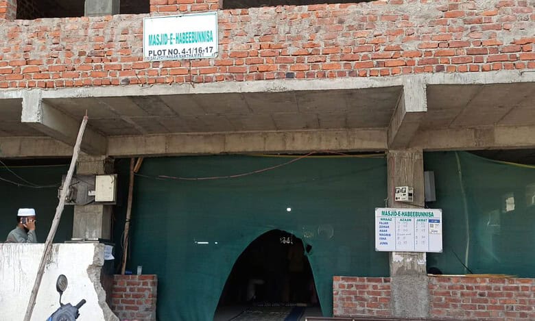 GHMC demolishes the boundary wall of Masjid-e-Habeeb Unnisa located at HMT Maqtha in Miyapur village of Serilingampally mandal using a bulldozer on Tuesday
