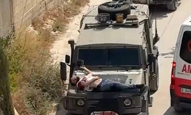 Israeli forces tie injured Palestinian man to jeep in West Bank