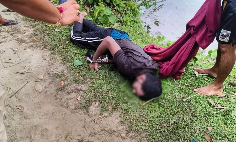 Body of prime accused in the alleged rape of a minor girl after being recovered from a pond, at Dhing, in Nagaon district, Saturday, Aug. 24, 2024. The accused allegedly escaped from police custody, jumped into a pond and died on Saturday morning at Dhing in Assam's Nagaon district, an official said. (PTI Photo)