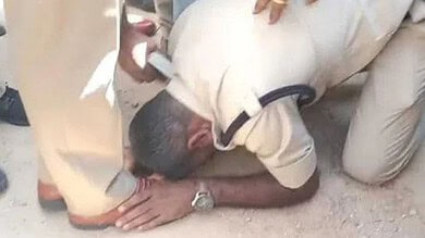 A battalion constable demanding 'One Police, One State' falling on the feet of Rajanna Sircilla SP during a protest on Saturday.