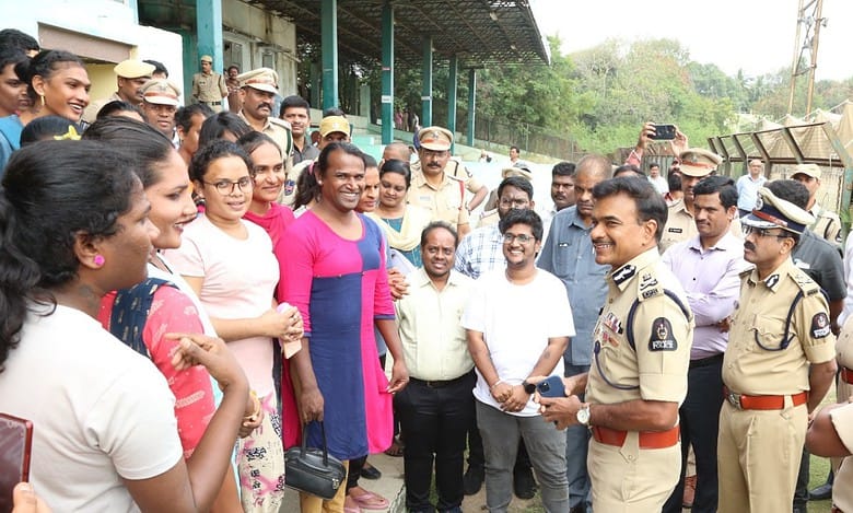 Image of Hyderabad police commissioner CV Anand speaking with newly recruited transgenders as traffic police assistants.