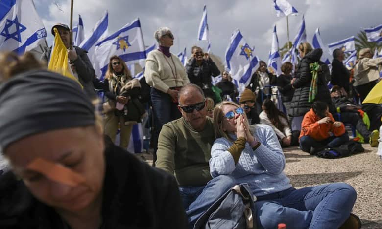People gather at Hostage Square in Tel Aviv, Israel, Thursday, Feb. 20, 2025, as Hamas hand over four bodies to the Red Cross in Gaza (AP Photo/Oded Balilty)