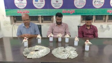 Three municipal officials apprehended by ACB Telangana for accepting a bribe, are seated behind a table