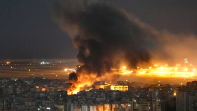 Representative image showing massive fire and thick smoke rising over buildings during a night-time airstrike.