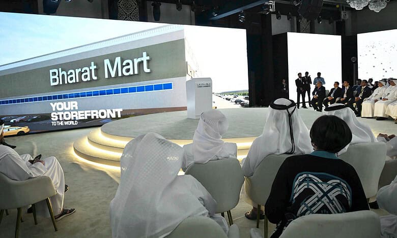Delegates attend the launch event of Bharat Mart in Dubai, with a large screen displaying the marketplace's name and slogan.