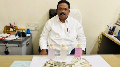 GHMC official Vipperla Srinivas sitting down after a chemical test confirmed he accepted a ₹70,000 bribe