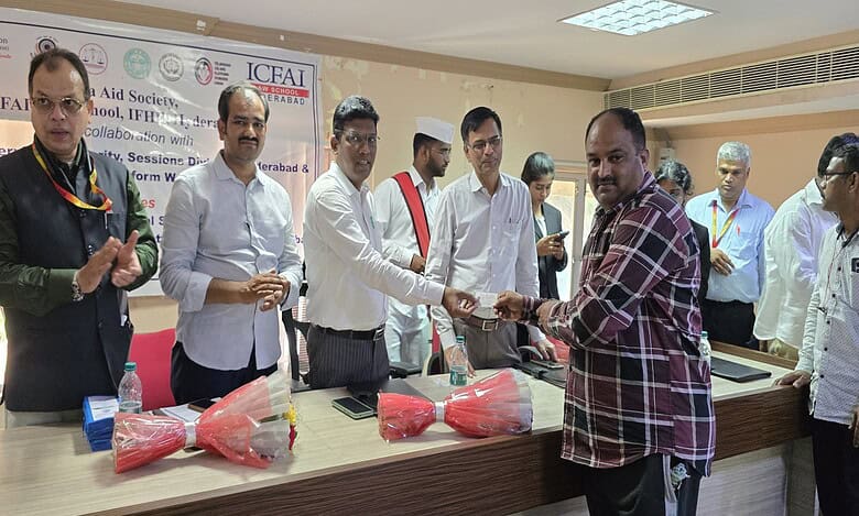 A Telangana Gig and Platform Workers Union member receives e-Shram card at a programme organised at ICFAI law school in Hyderabad