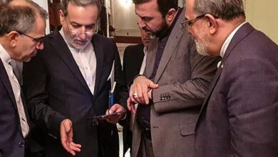 Iranian Foreign Minister Abbas Araghchi (second from left) engaged in conversation with members of his delegation during a break in meetings in Muscat.