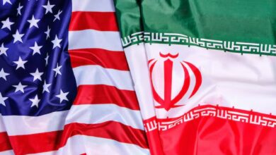 Close-up image showing the national flags of the United States and Iran side by side, symbolising diplomatic relations and geopolitical tensions between the two countries.