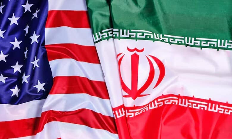 Close-up image showing the national flags of the United States and Iran side by side, symbolising diplomatic relations and geopolitical tensions between the two countries.