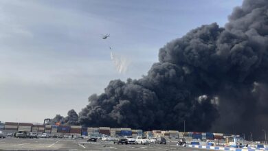 A helicopter drops water to battle a massive fire after an explosion at Shahid Rajaei Port near Bandar Abbas, southern Iran, on April 26.