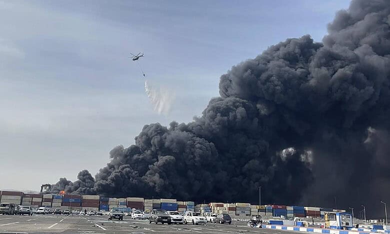 A helicopter drops water to battle a massive fire after an explosion at Shahid Rajaei Port near Bandar Abbas, southern Iran, on April 26.