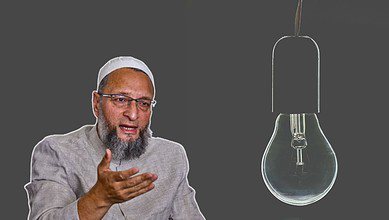 Asaduddin Owaisi wearing a light gray traditional outfit and white cap gestures with their hands against a dark background. To the right, a large, unlit light bulb is depicted.