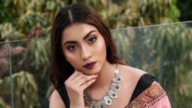 Meghna Alam, former Miss Earth Bangladesh, poses in traditional attire with statement jewellery, photographed outdoors against a natural green backdrop.