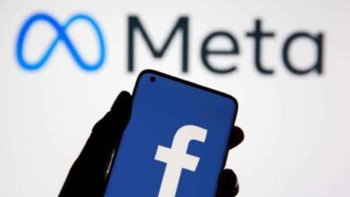 A smartphone displaying the Facebook logo in front of the Meta company logo, representing Meta Platforms, the parent company of Facebook.
