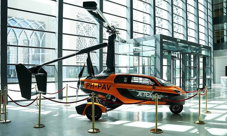 PAL-V Liberty flying car on display indoors at Sharjah Research, Technology and Innovation Park.