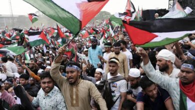 Thousands of protesters wave Palestinian flags during a mass rally against Israel in Dhaka, Bangladesh, showing solidarity with Palestinians amid ongoing conflict.