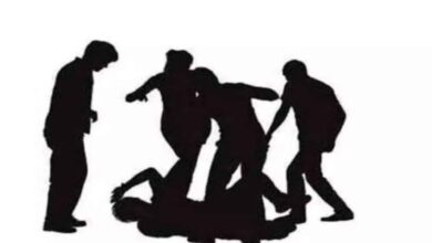 Representational Image of group of people thrashing a man