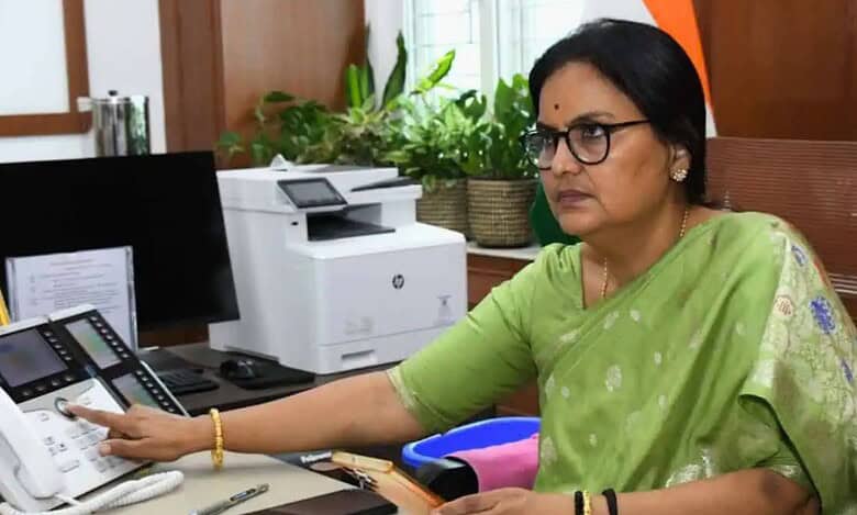 Santhi Kumari on a conference call in her office