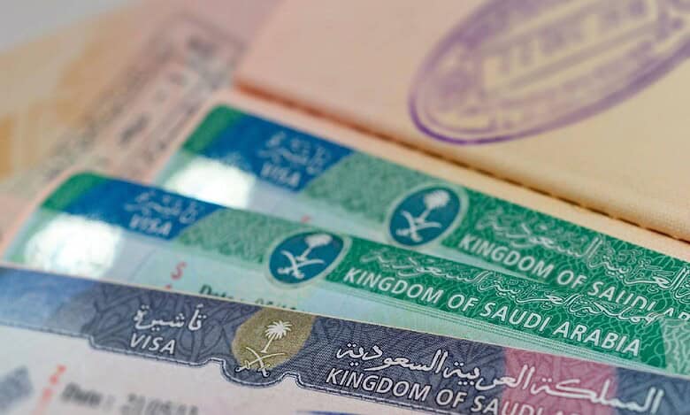 Close-up of multiple Saudi Arabian visas inside a passport, showing official visa stamps issued by the Kingdom of Saudi Arabia.