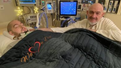 Saudi 'Sleeping Prince' Al-Waleed bin Khaled lies in a hospital bed with medical equipment around him, as his father sits beside him offering silent support.