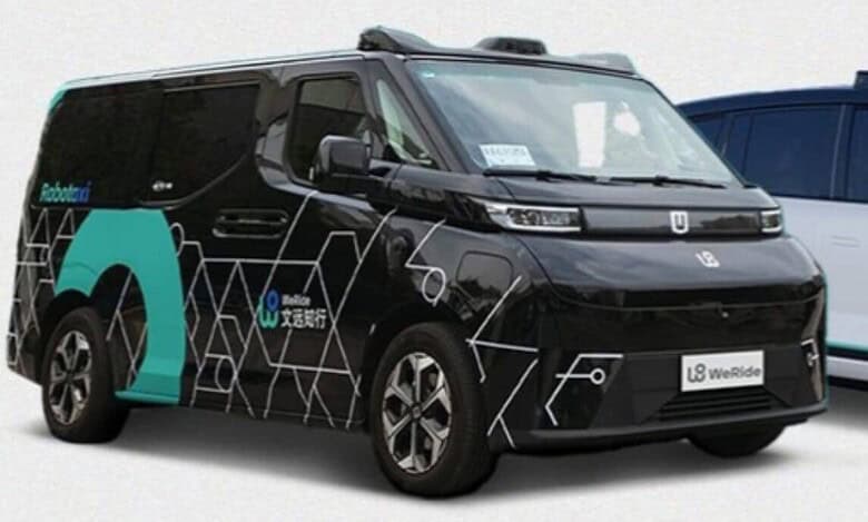 Self-driving taxi by WeRide, a black autonomous vehicle with futuristic hexagonal patterns, showcased with 'Robotaxi' branding. The vehicle, designed for urban smart mobility, features advanced sensors on its roof for autonomous navigation.