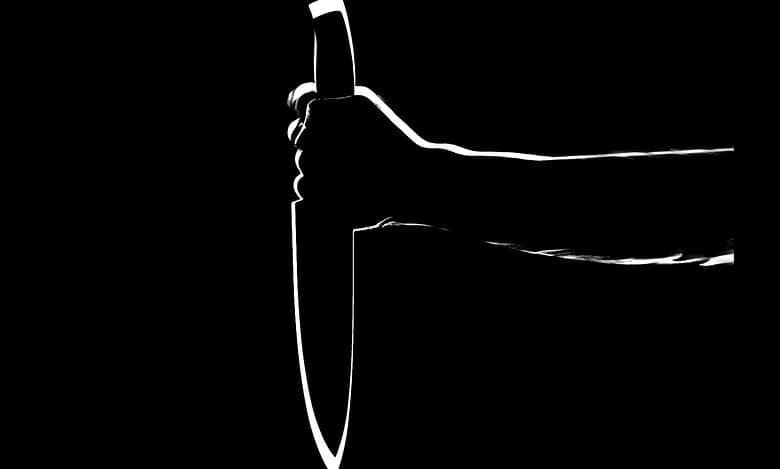 Individual holding a knife