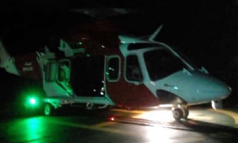Representative image of rescue helicopter on helipad in the dark, ready for take-off.
