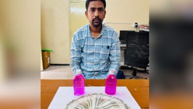 The image shops a man with stack of Indian rupees in front of him