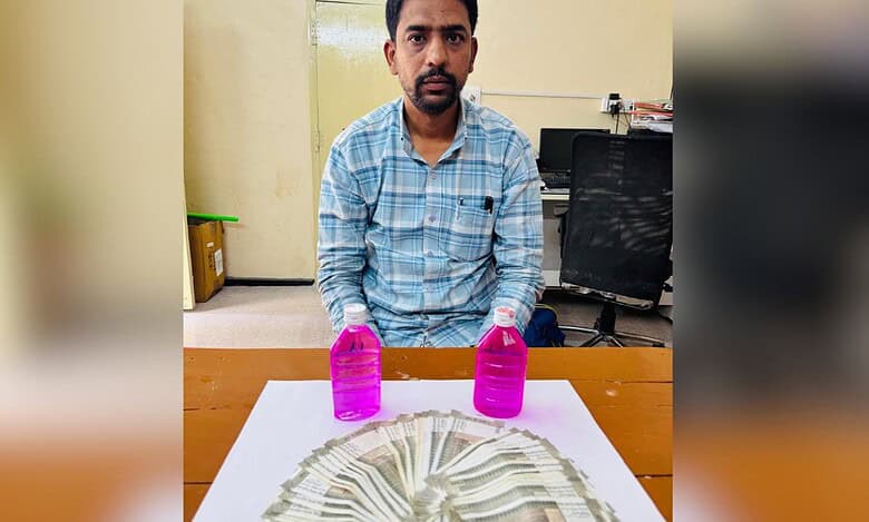The image shops a man with stack of Indian rupees in front of him