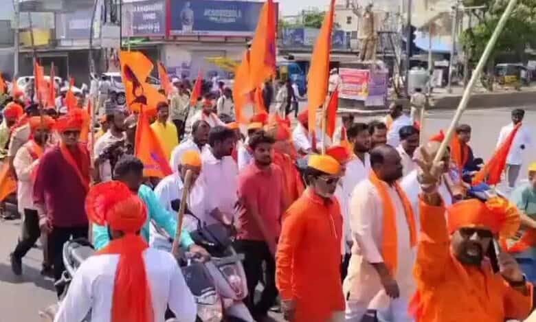 In the image, saffron clad Hindu devotees take part in Hanuman Jayanthi in Hyderabad