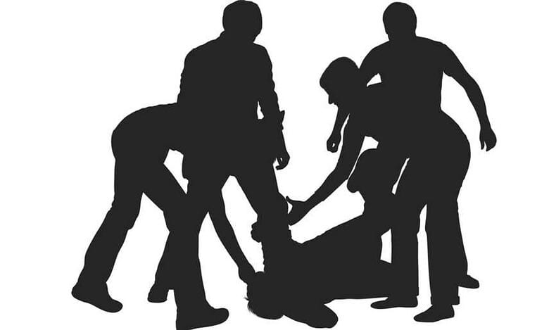 The image displays a representational image of attack on Kashmiri students
