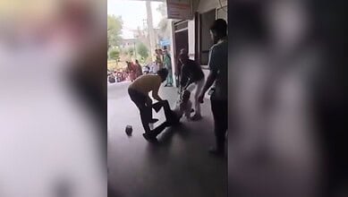The image displays a senior citizen being dragged by a few men in a district hospital in Madhya Pradesh