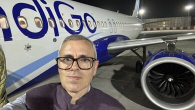 The image shows a selfie picutre of J&K CM Omar Abdullah in front of an IndiGo airline at the Delhi Airport