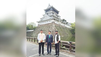 The image displays the picture of Telangana CM Revanth Reddy and It minister D Sridhar Babu with Kitakyushu mayor Kazuhisa Takeuchi