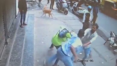 The image displays a CCTV footage of an Air Force officer attacking a biker in Bengaluru. April 21, 2025