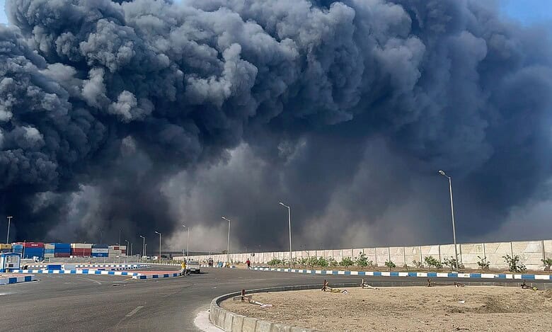 The image shows thick smoke billowing from an Iranian port after a blast was reported, leaving over 400 injured.