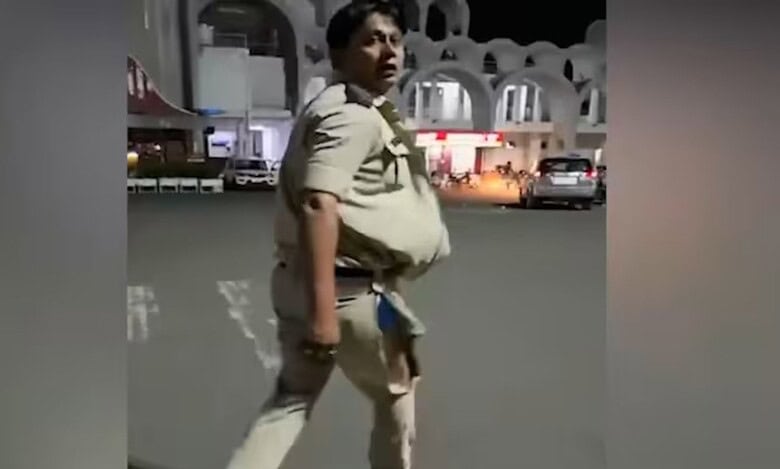 The image displays a picture of a GRP officer with his uniform ripped off from a scuffle in Bhopal