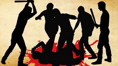 The image displays a representational image of an angry mob attacking with sticks