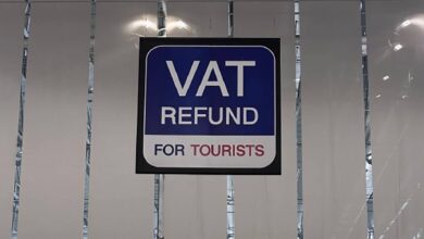 VAT refund sign for tourists displayed at an international airport, indicating tax reclaim services available for non-resident shoppers.