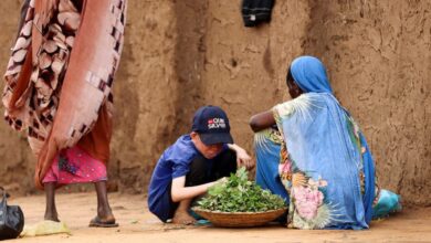 Displaced Sudanese people sit at Zamzam camp, in North Darfur, Sudan.