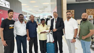 Gopalan Chandran, an Indian expatriate stranded for 42 years in Bahrain, seen at the airport with supporters and embassy officials before boarding his flight home to Kerala.